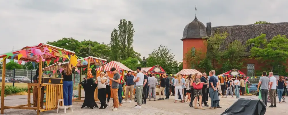 Jahrmarkt: Personen vor Jahrmarktbuden